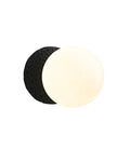 Round wall sconce with an opaque white glass globe and a textured black cement base.