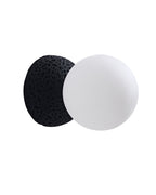 Side view of a round wall sconce with an opaque white glass globe and a textured black cement base.
