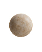 Front view of a spherical wall sconce made of natural travertine stone with a textured surface.