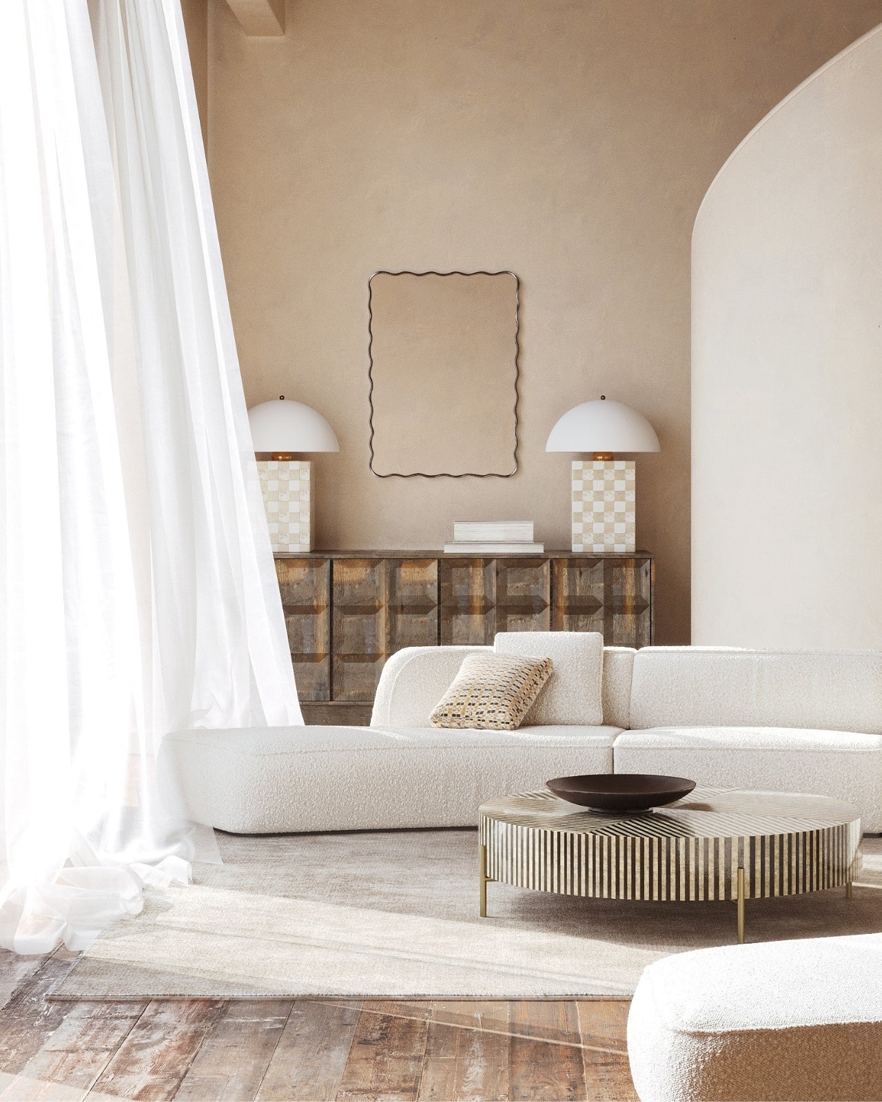 Rectangular wall mirror with a black frame and softly wavy edges, mounted above a sideboard in a neutral living room setting.