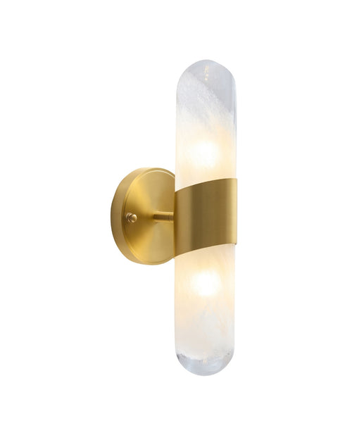 Brass wall sconce with a slim vertical textured glass tube, softly illuminated and held at the center by a curved brass band, mounted on a round brass wall plate.