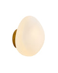 Brass wall sconce with an oval opaque white glass shade mounted on a round brass backplate.