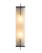 Agatha oversized wall sconce with a tall rectangular alabaster shade emitting warm diffused light, framed by slim black copper accents, shown front-facing on a white background.