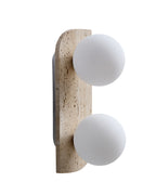 Travertine wall sconce with two round white glass globes mounted vertically.