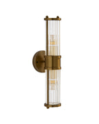 Brimsley II Wall Sconce with a vertical brass frame and ripple-textured clear glass, shown unlit on a white background, highlighting its sleek, elongated silhouette and refined detailing.