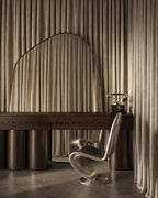 XXL organic wall mirror with black frame positioned above a dark wood desk with a chair and rotary phone.