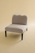 Beige linen upholstered accent chair with a curved backrest and black metal legs.