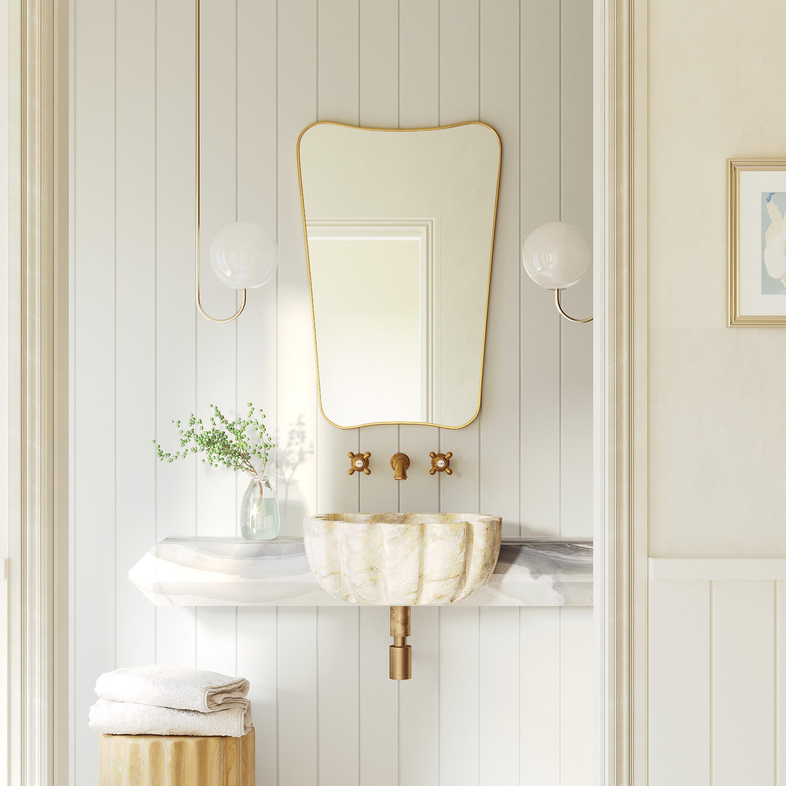 Butterfly Mirror with an irregular, wing-inspired shape mounted above a wall-mounted sink, styled with symmetrical wall sconces and minimal decor in a bright bathroom setting.