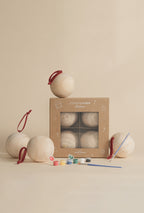 Bambino Wooden Ornament painting kit with four unfinished pine wood ornaments, paint set, two brushes, and Ethnik Living gift box.