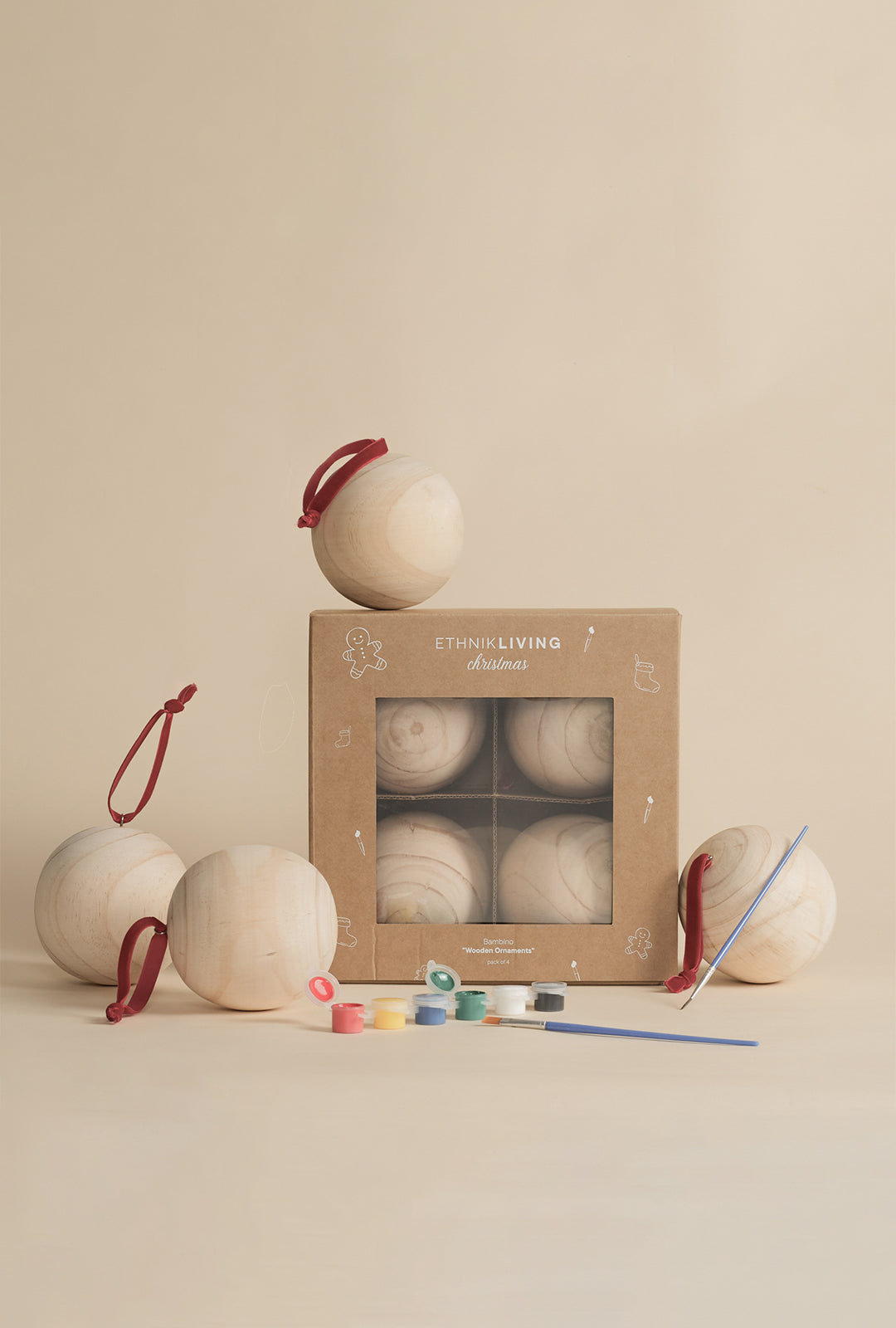 Bambino Wooden Ornament painting kit with four unfinished pine wood ornaments, paint set, two brushes, and Ethnik Living gift box.