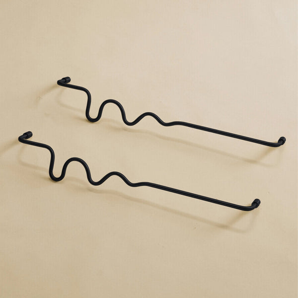 Two black wavy towel bars displayed on a neutral studio background.