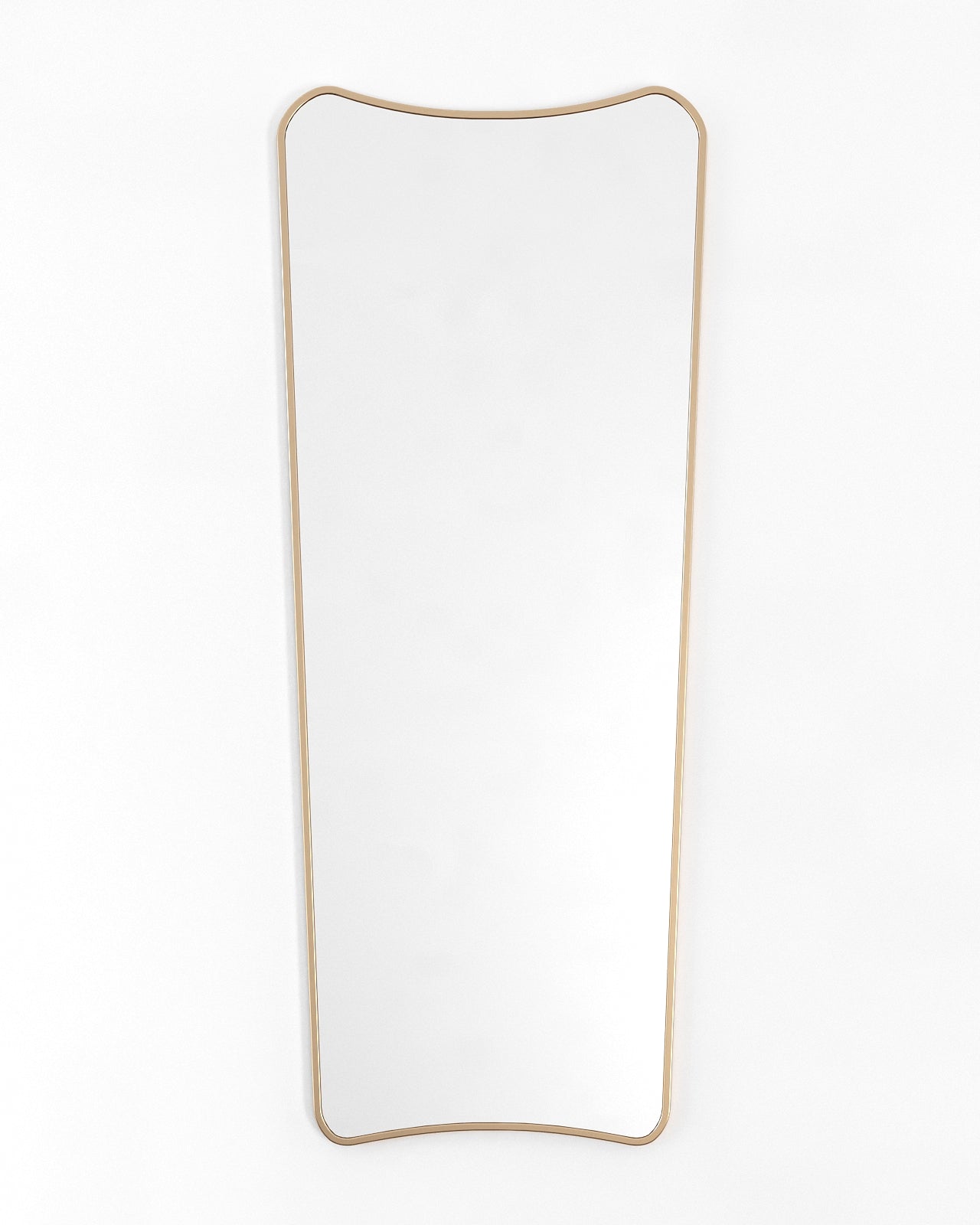 Brass framed full-length mirror with a softly curved, asymmetrical outline, shown front-facing against a white background.