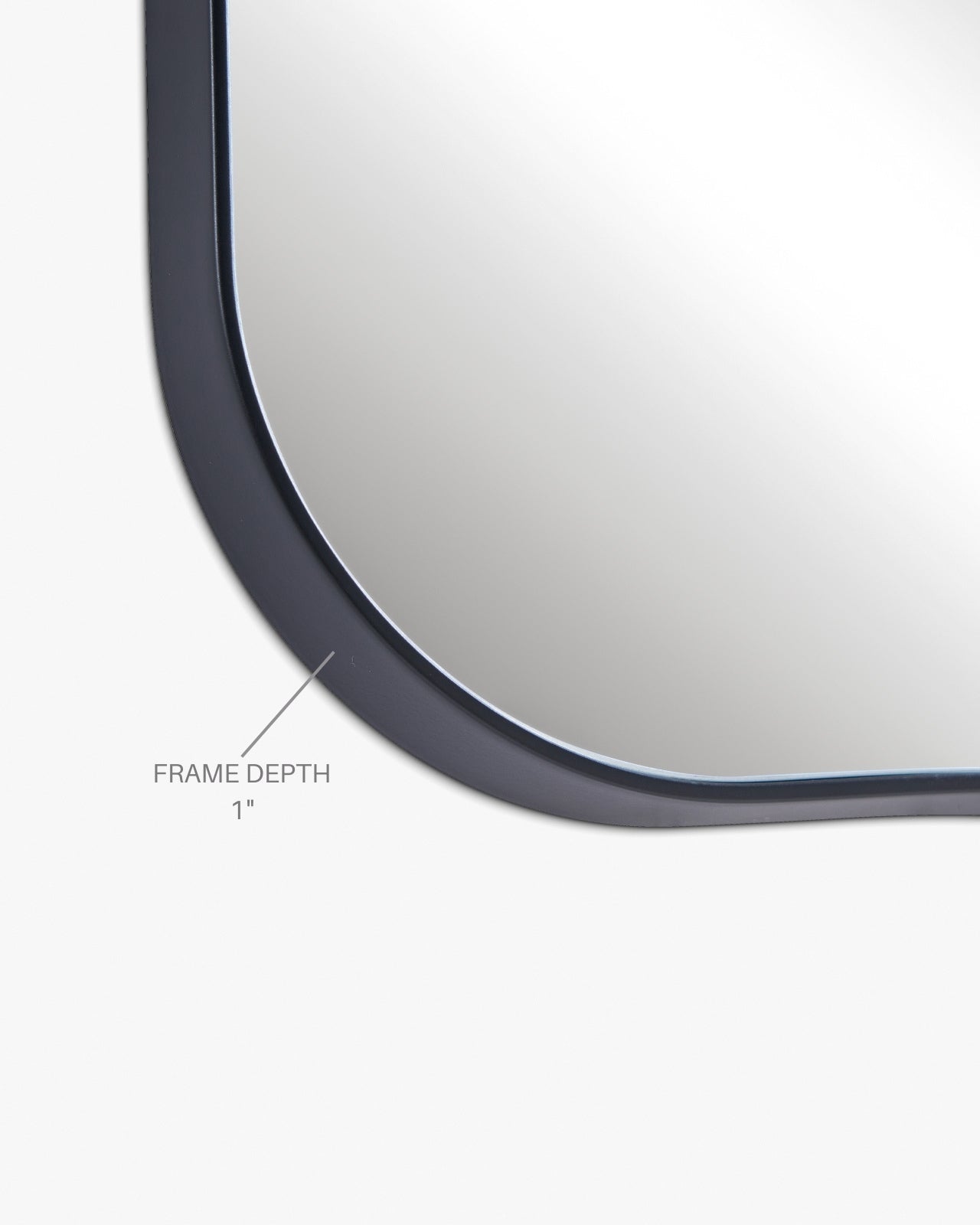 Asymmetrical wall mirror close-up showing a thin black frame with a labeled 1-inch frame depth on a white background.