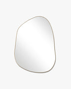 Asymmetrical mirror with an organic shape and a thin brass-colored frame on a white background.