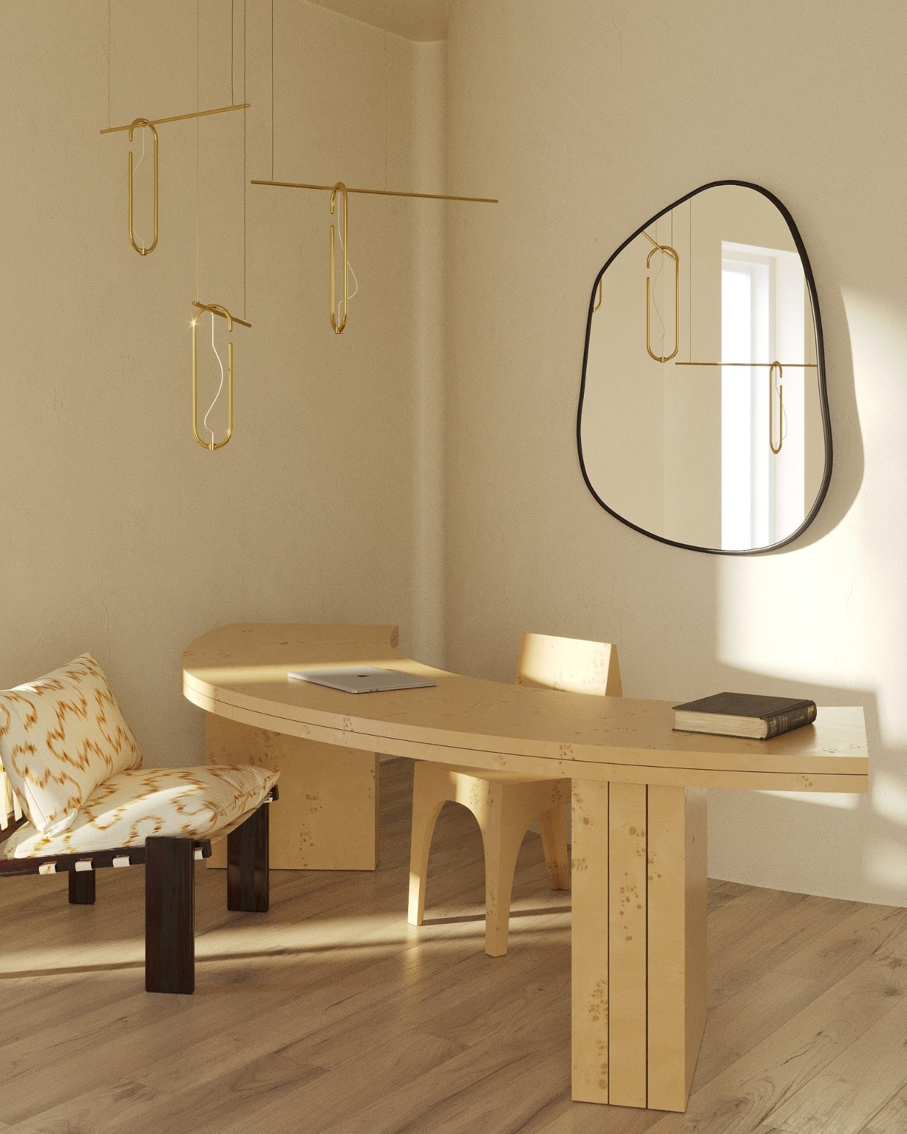 Asymmetrical wall mirror mounted above a sculptural wooden desk in a minimalist workspace with hanging brass light fixtures and natural wood flooring.