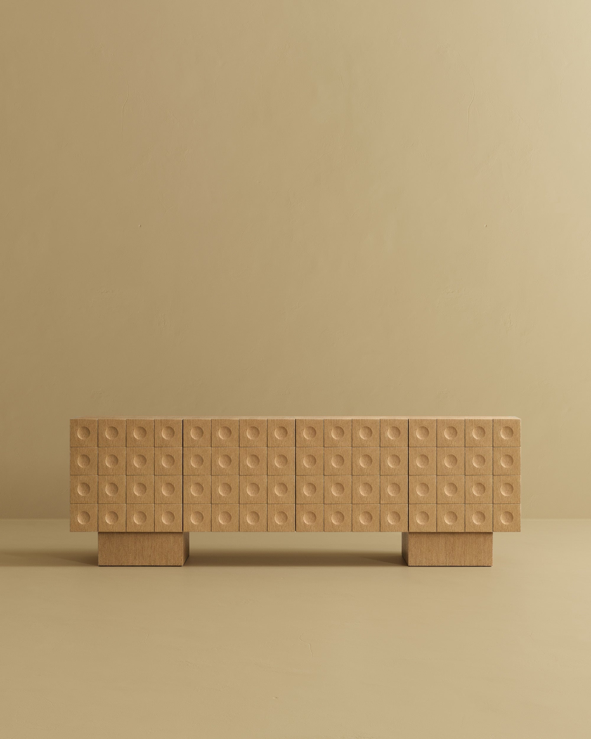 Modern wood sideboard with a grid of circular textured drawer fronts on a neutral beige background.