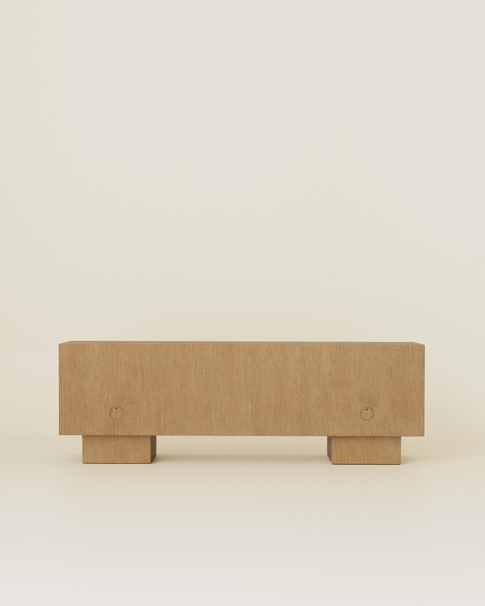 Back view of a wooden sideboard with block legs against a neutral background.