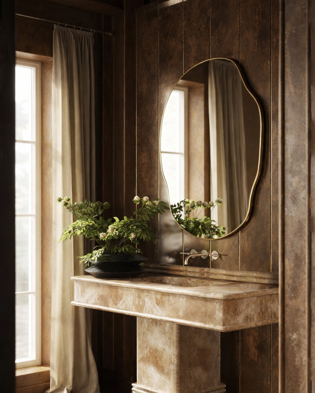Asymmetrical brass-framed wall mirror installed above a stone console vanity.