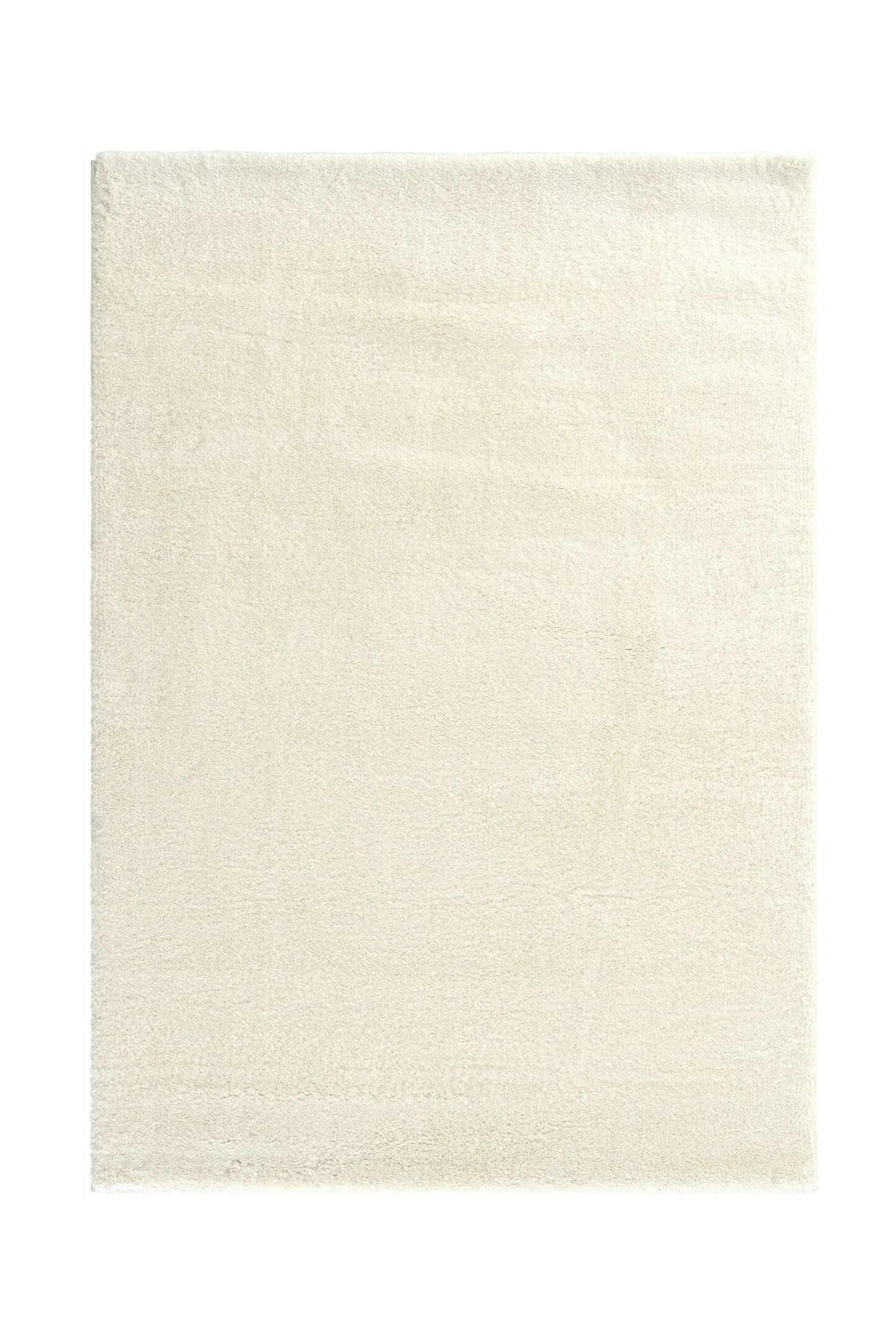 Beige rectangular handcrafted rug with a soft, smooth texture.