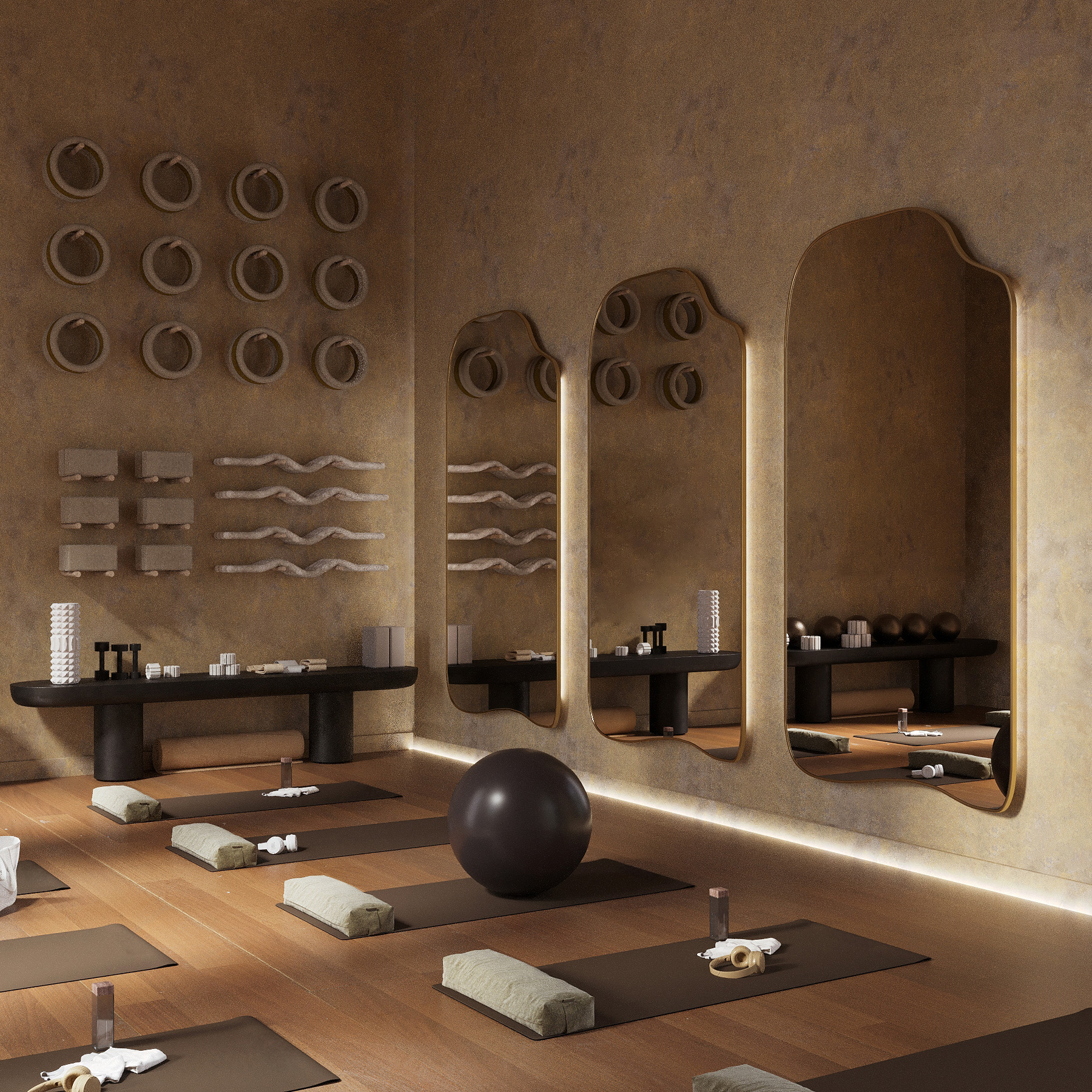Asymmetrical full-length mirrors with organic shapes mounted in a yoga studio featuring exercise mats, props, warm lighting, and wood flooring.