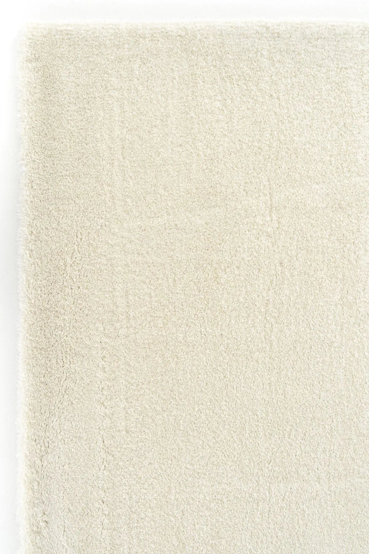 Beige textured rug with soft, plush surface.