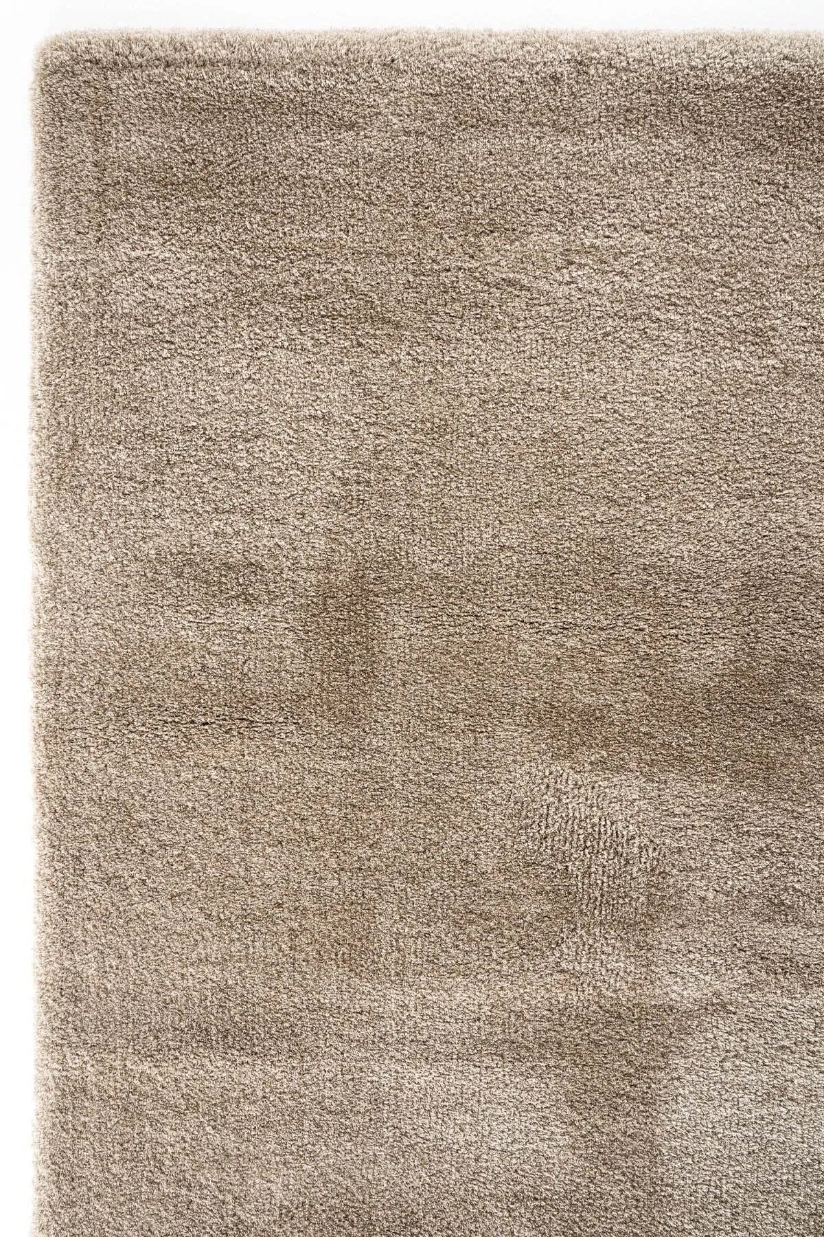 Brown rectangular handcrafted rug with a soft, plush texture and subtle tonal variation.