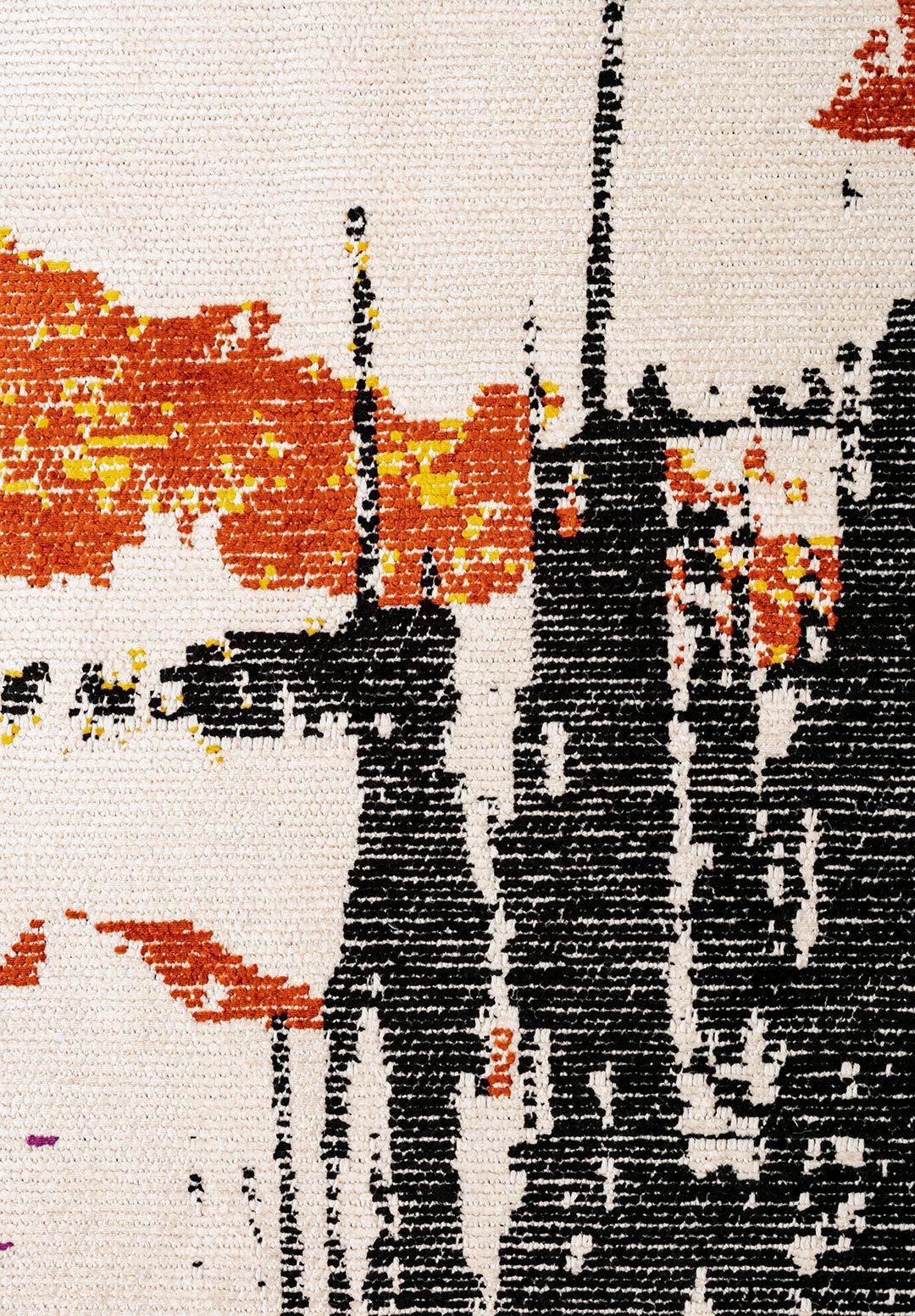 Close-up of abstract rug pattern in black, orange and yellow.