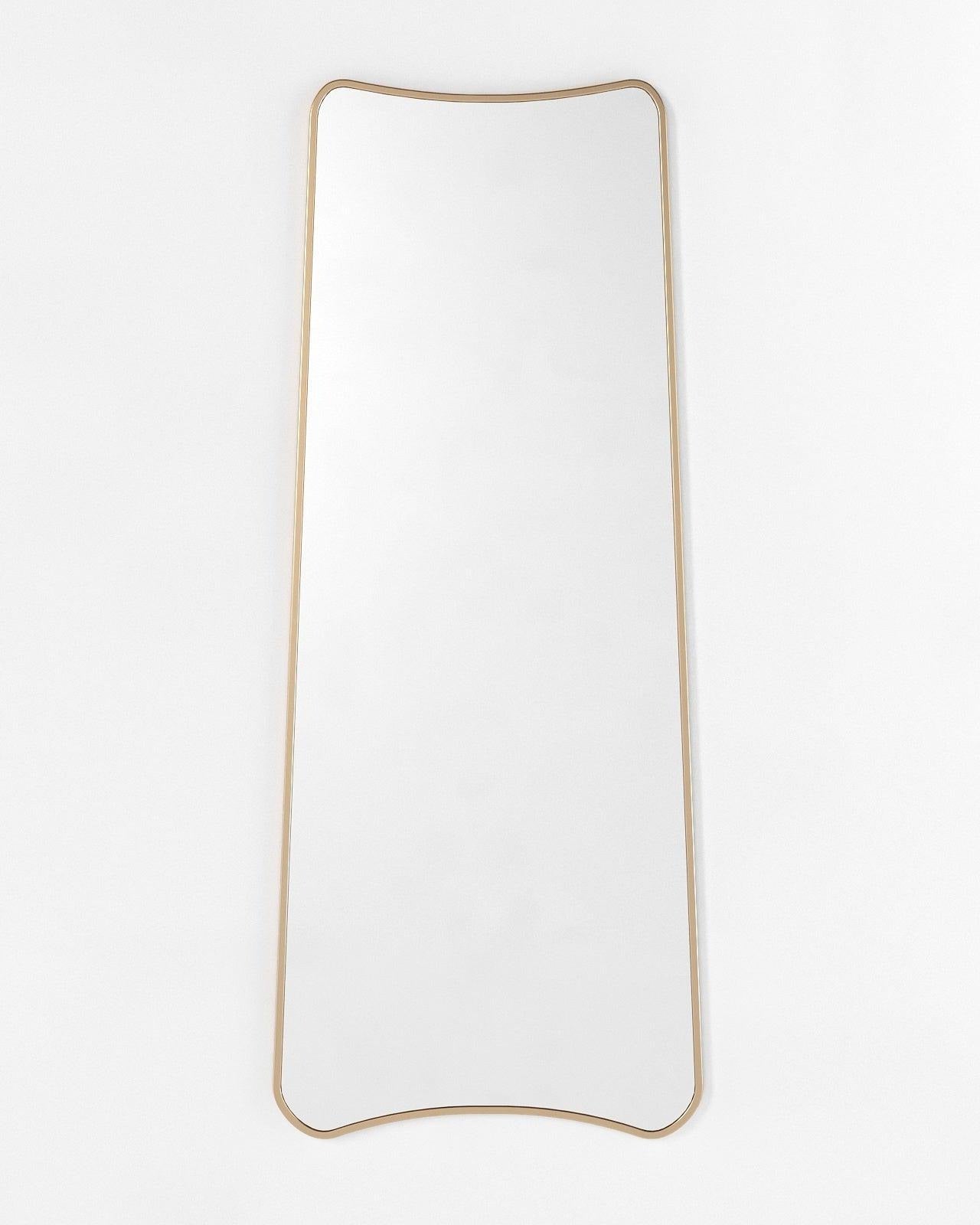 Tall full-length mirror with a narrow rectangular form and gently curved top and bottom edges, shown vertically against a plain light background.