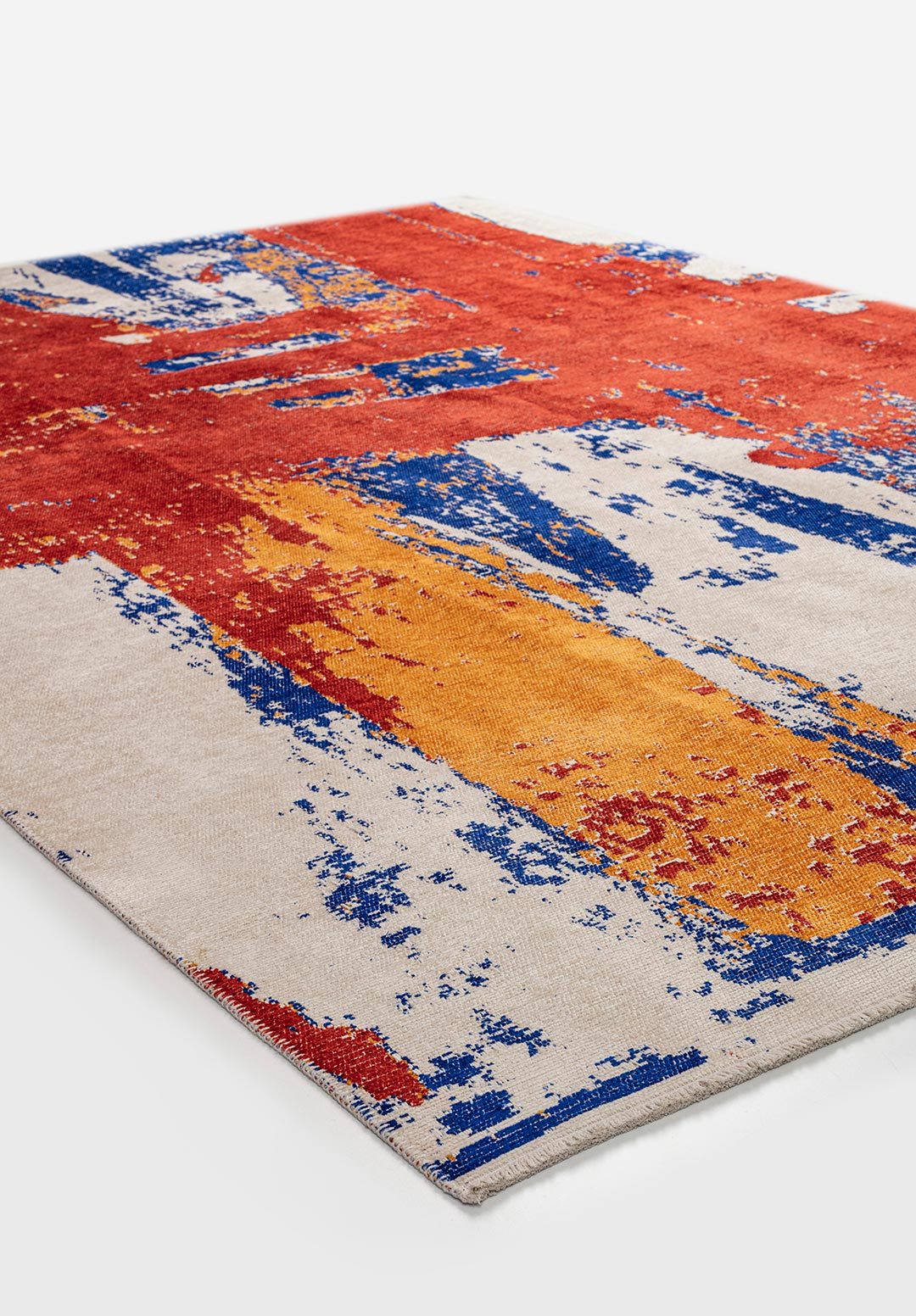 Angled view of abstract flat-woven rug with multicolor pattern.