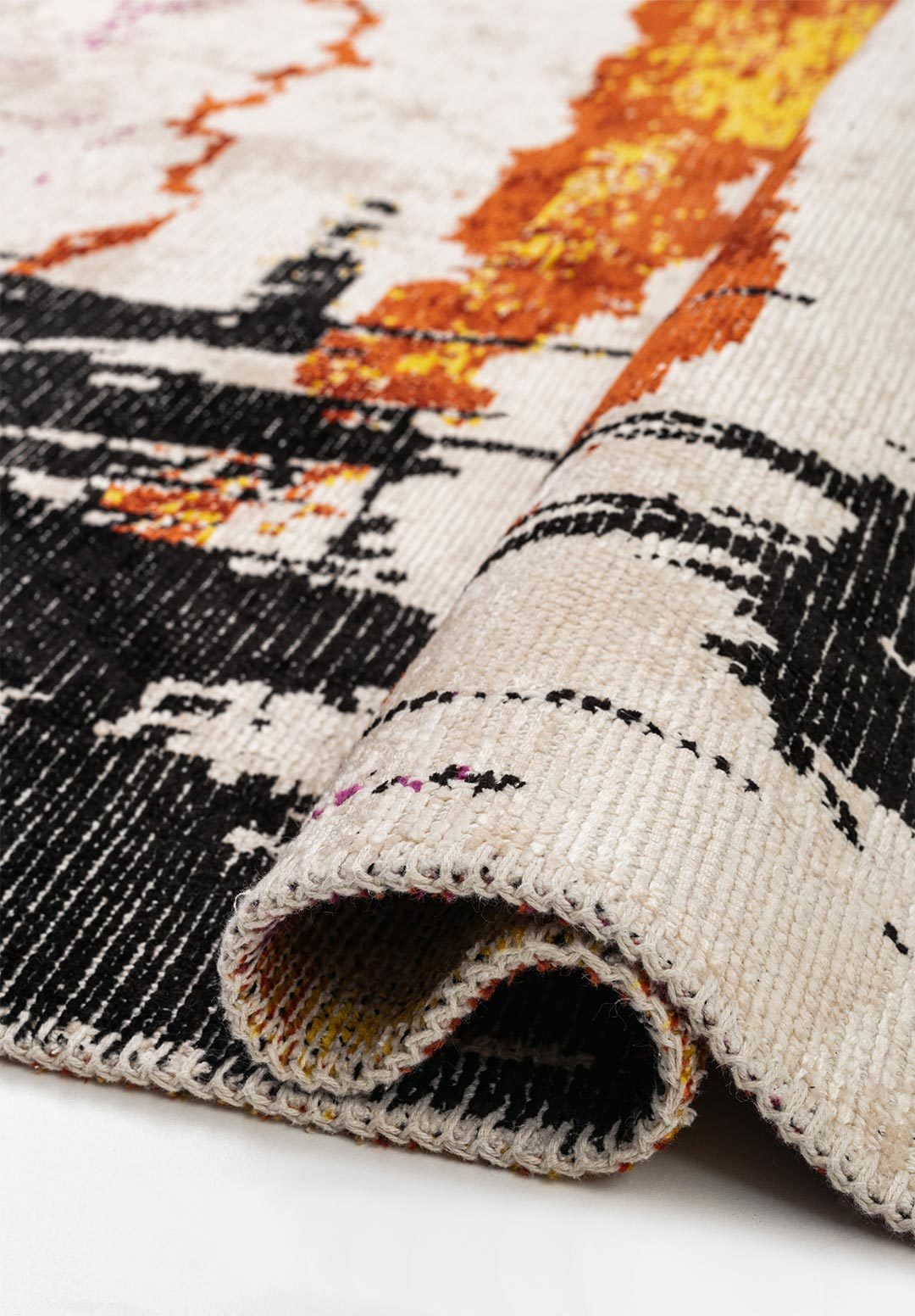 Close-up detail of abstract multicolor flat-woven rug.